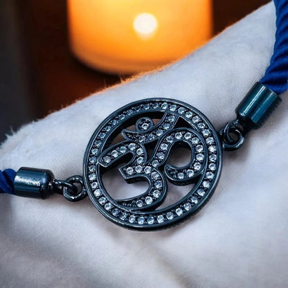 Close-up of Om symbol adorned with sparkling American Diamonds on a copper bracelet.